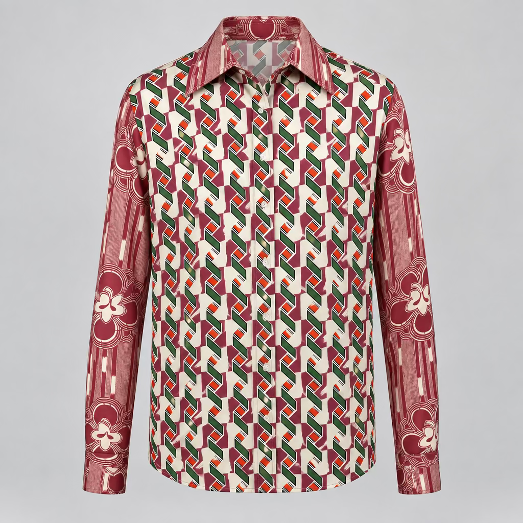 The shirt features a bold geometric pattern with red, green, orange, and black shapes on a white base, with red and cream sleeves and collar.