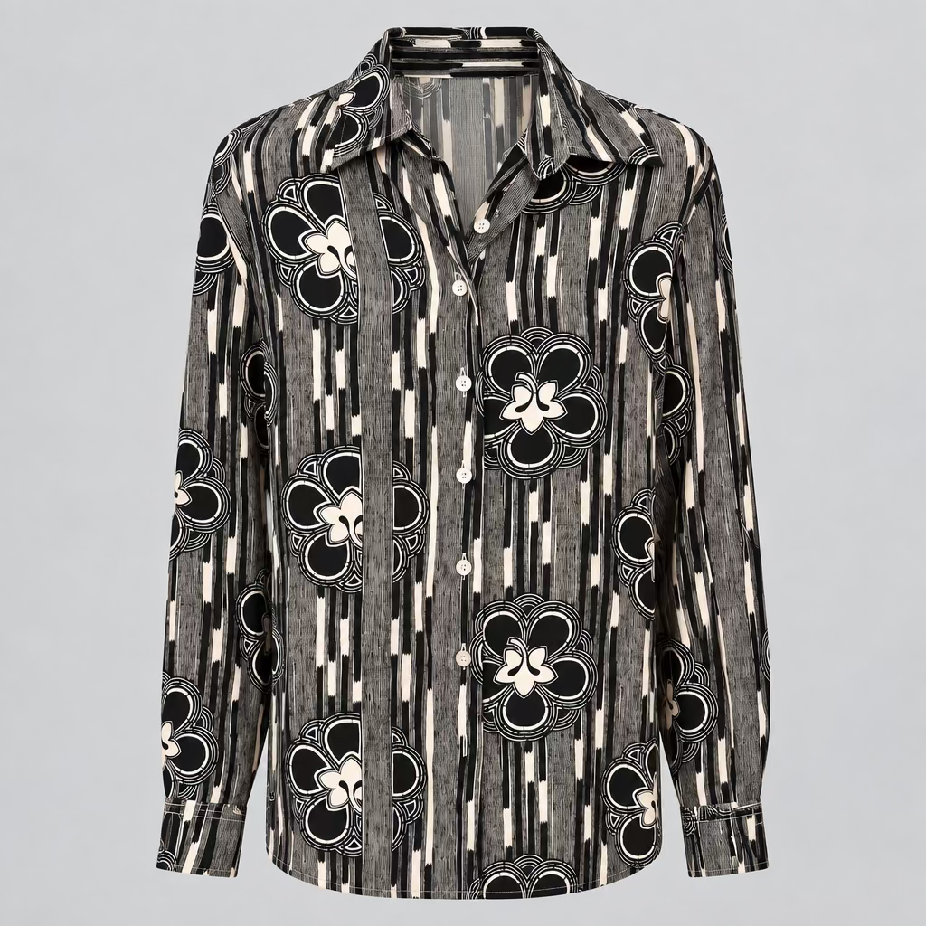A long-sleeve button-up shirt with a black, white, and gray floral and geometric pattern, displayed on a white mannequin torso inside a retail store.