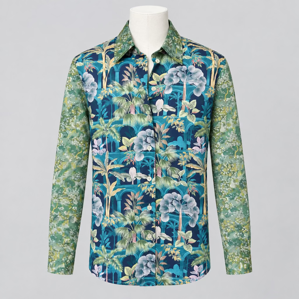 A long-sleeve button-up shirt with a vibrant tropical floral and palm tree print, displayed on a white mannequin torso in a clothing store.