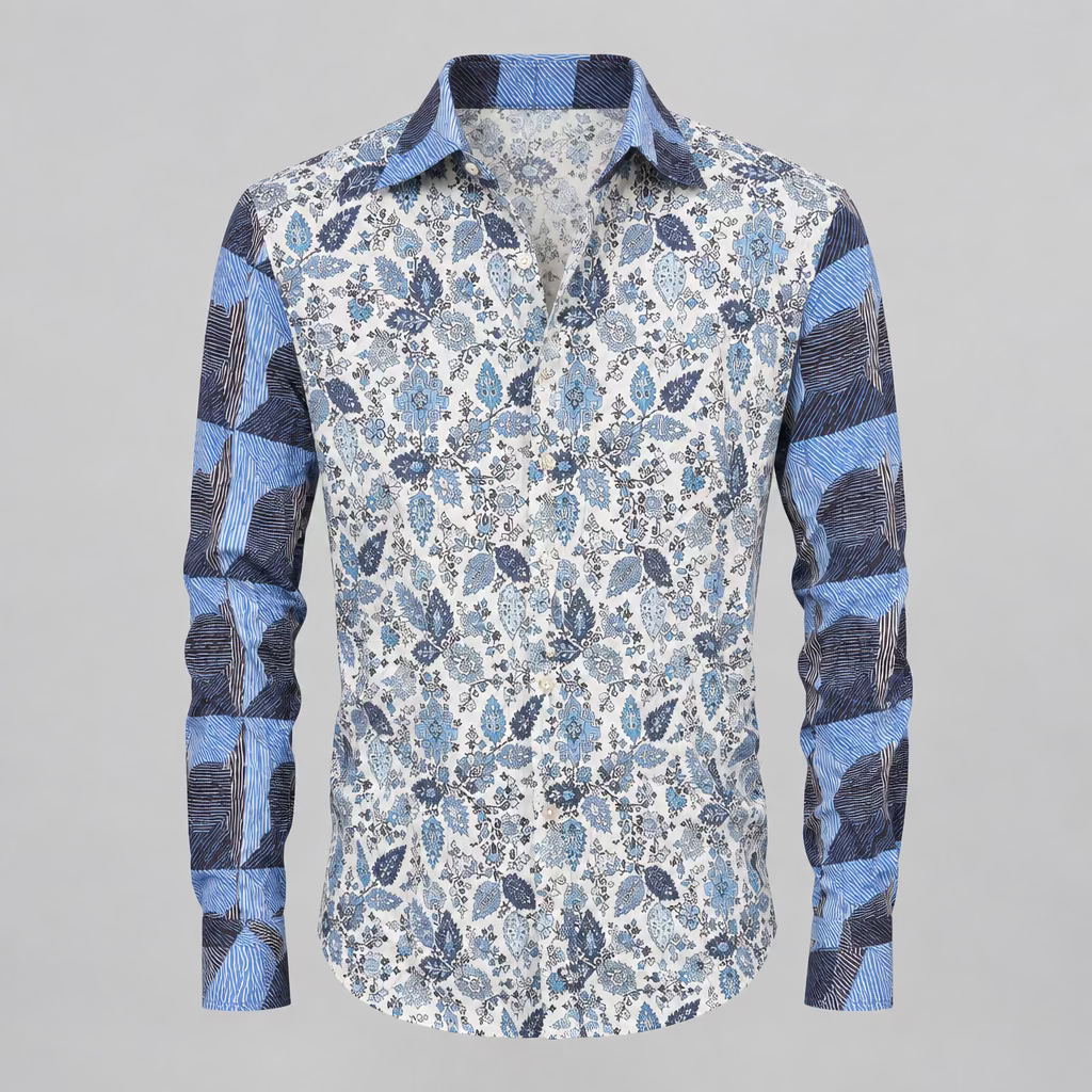 A long-sleeve button-up shirt with a blue, gray, and white paisley pattern, displayed on a white mannequin torso inside a clothing boutique.