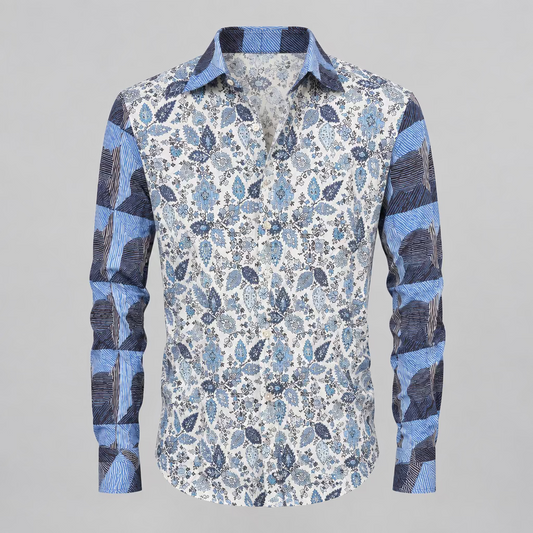 A long-sleeve button-up shirt with a blue, gray, and white paisley pattern, displayed on a white mannequin torso inside a clothing boutique.